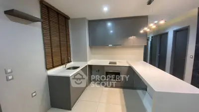 Modern kitchen with sleek cabinetry and integrated appliances in a stylish apartment.