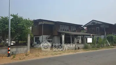 Charming rustic wooden house with spacious yard and lush greenery