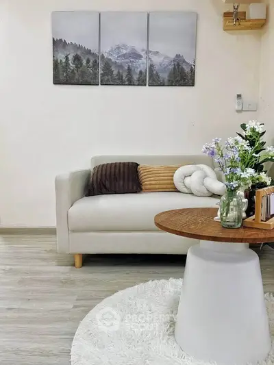 Charming living room with cozy sofa, elegant decor, and stylish coffee table in modern apartment.