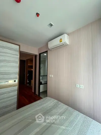 Modern bedroom with air conditioning and stylish decor in a contemporary apartment.