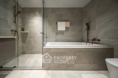Luxurious modern bathroom with elegant bathtub and sleek shower design.
