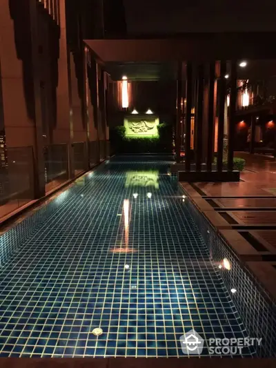 Luxurious rooftop pool with ambient lighting in modern building