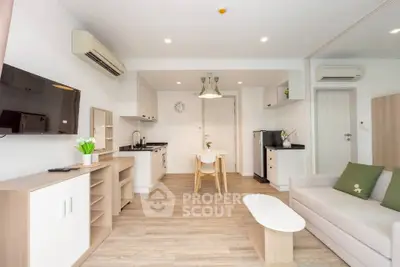 Modern open-plan living room with sleek kitchen and stylish decor