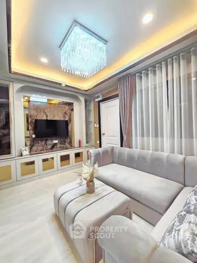 Luxurious living room with elegant chandelier and plush sofa