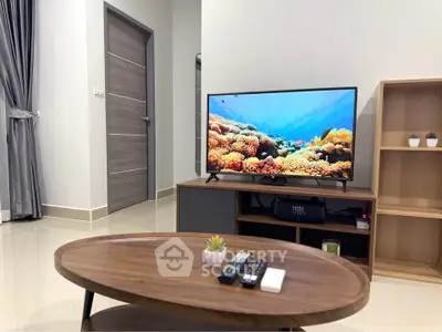 Modern living room with sleek TV setup and stylish wooden furniture
