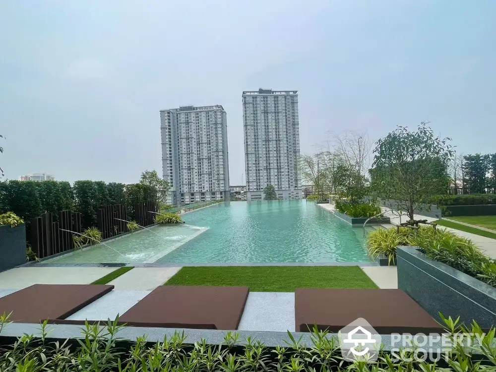 Luxurious condominium with stunning pool and skyline view, perfect for relaxation and urban living.