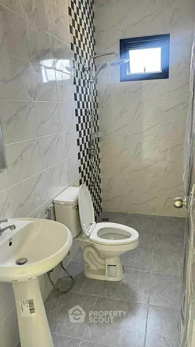 Modern bathroom with stylish tiles and natural light