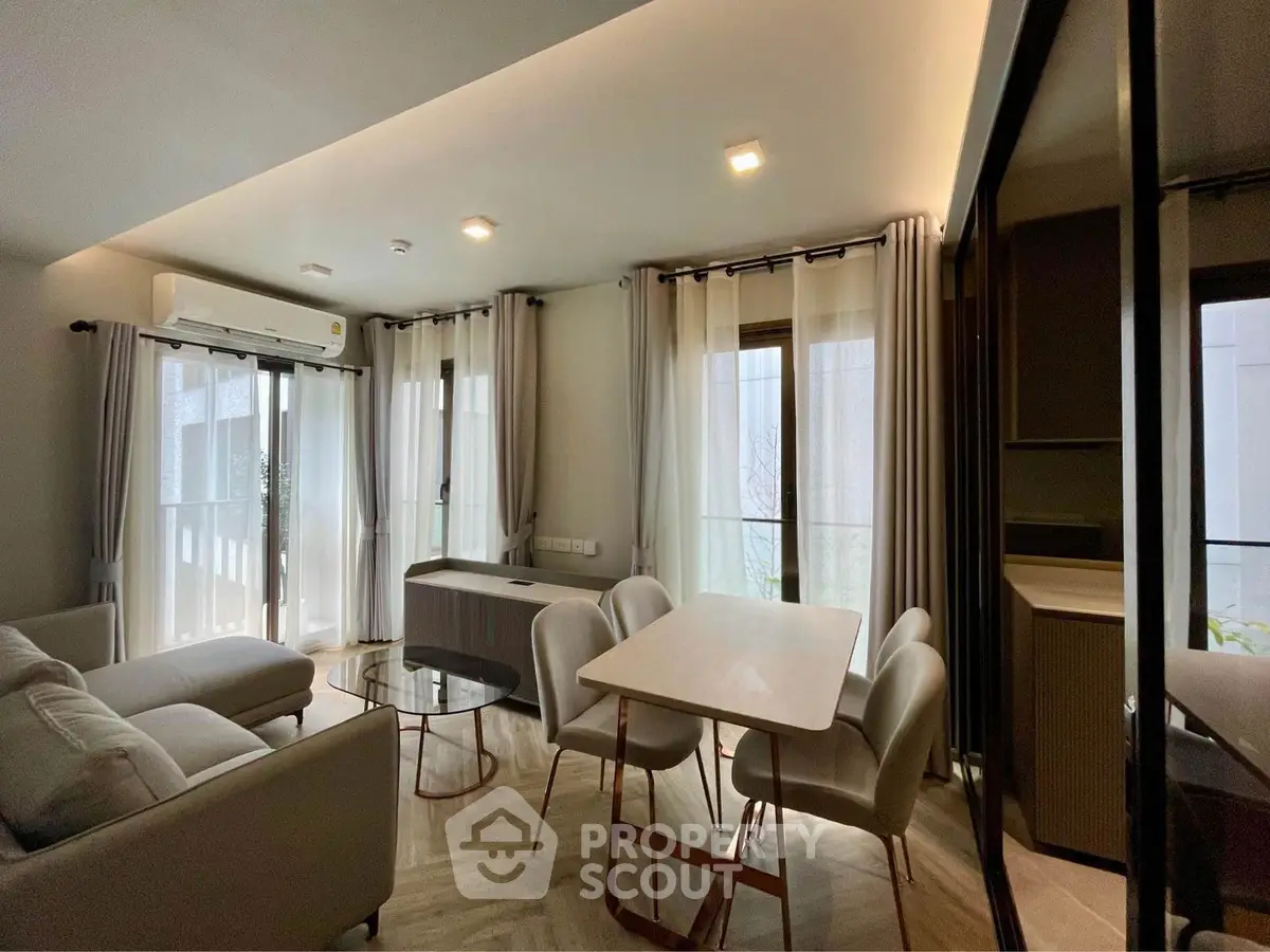 Modern living room with elegant dining area and natural light