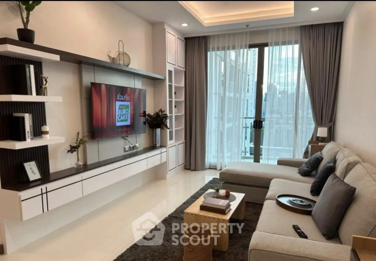 Modern living room with stylish decor and large balcony view in urban apartment.