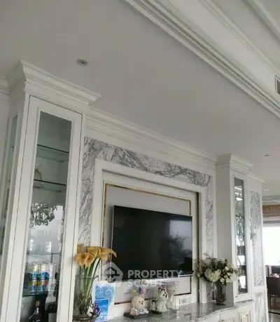 Luxurious living room with elegant marble TV wall and decorative accents