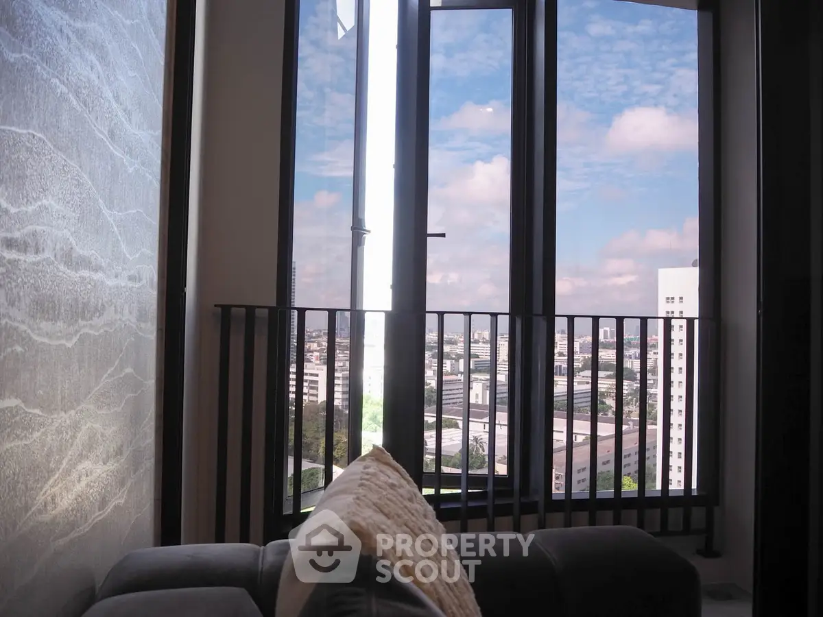 Modern apartment with stunning city view from large windows and cozy interior.