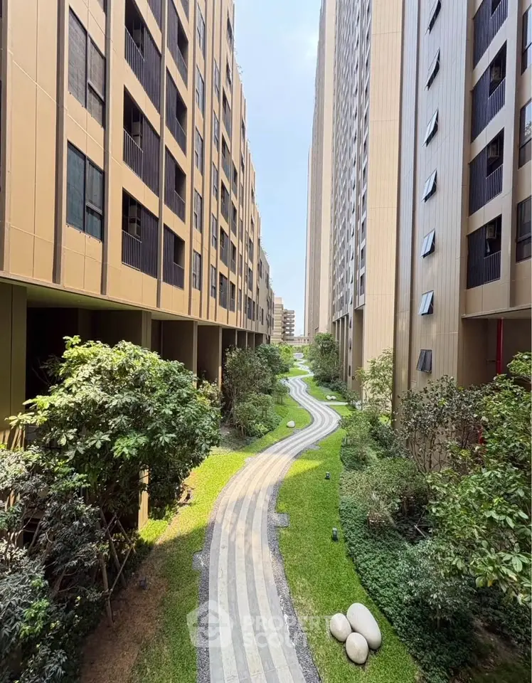 Stunning view of modern apartment buildings with lush garden pathway.