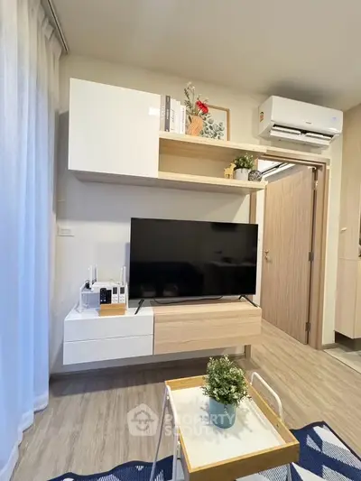 Modern living room with sleek TV unit and air conditioning, featuring stylish decor and cozy ambiance.