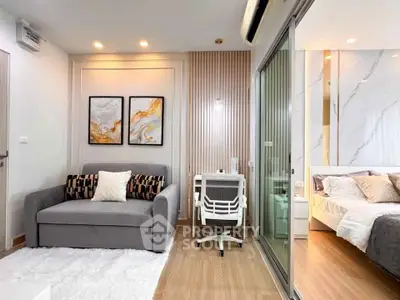 Modern living room with stylish decor and cozy bedroom view in open layout apartment.