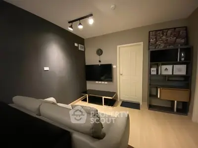 Modern living room with sleek design and wall-mounted TV, perfect for cozy evenings.