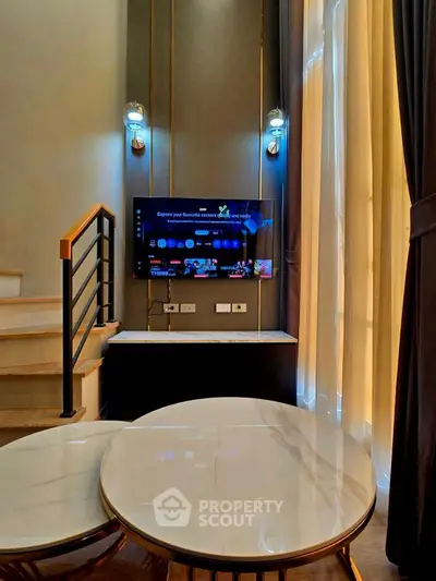 Modern living room with stylish decor and wall-mounted TV