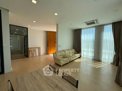 Spacious modern living room with natural light and elegant furnishings