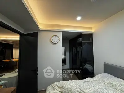 Modern bedroom with stylish lighting and open wardrobe design