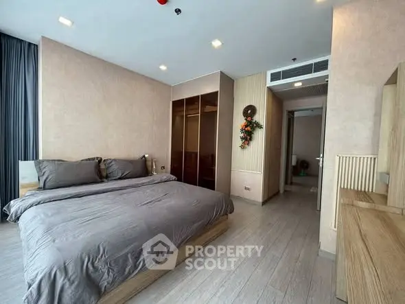 Spacious modern bedroom with elegant decor and ample natural light