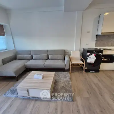 Modern living room with sleek furniture and stylish kitchen corner