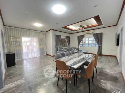 Spacious modern dining room with elegant marble flooring and stylish furniture