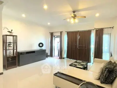 Spacious living room with modern decor and ample natural light