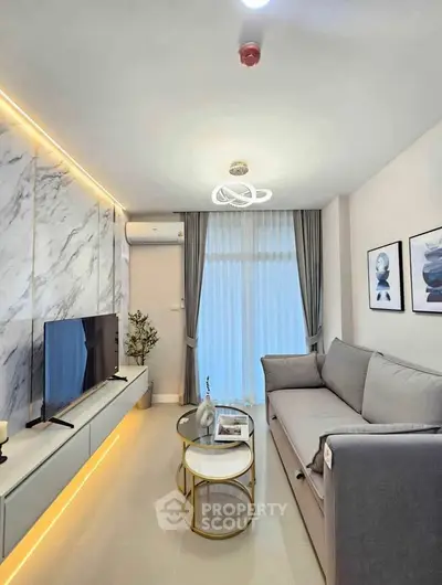 Modern living room with elegant decor, marble accent wall, and cozy gray sofa.