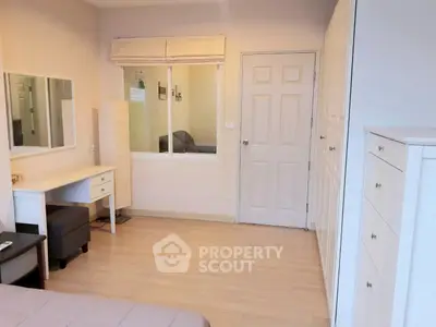 Cozy bedroom with modern furnishings and ample storage space