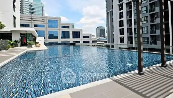 Luxurious high-rise apartment complex with stunning outdoor pool and modern architecture.
