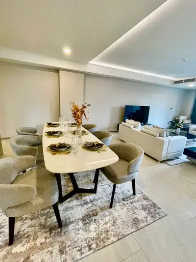 Spacious modern living room with elegant dining area and cozy seating arrangement.