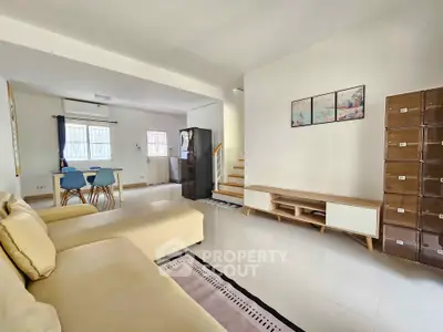 Spacious living room with modern furniture and open layout, perfect for family gatherings.