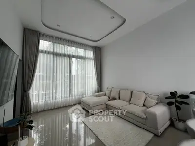 Modern living room with elegant sofa and large window