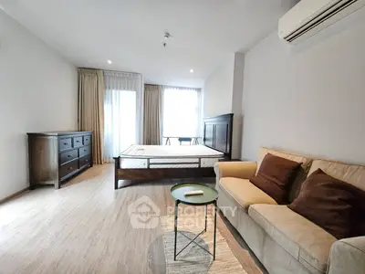 Spacious bedroom with elegant furnishings and natural light