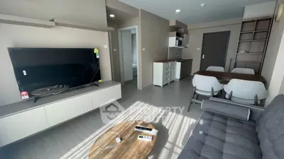 Modern living room with sleek furniture and open kitchen layout, perfect for contemporary living.