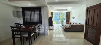 Spacious open-plan living and dining area with modern furnishings and natural light.
