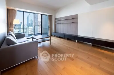 Spacious modern living room with city view and sleek wooden flooring.