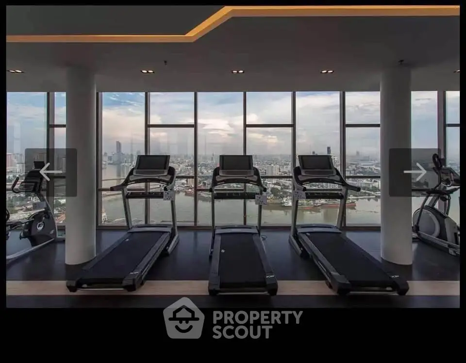 Luxurious gym with panoramic city view and modern treadmills