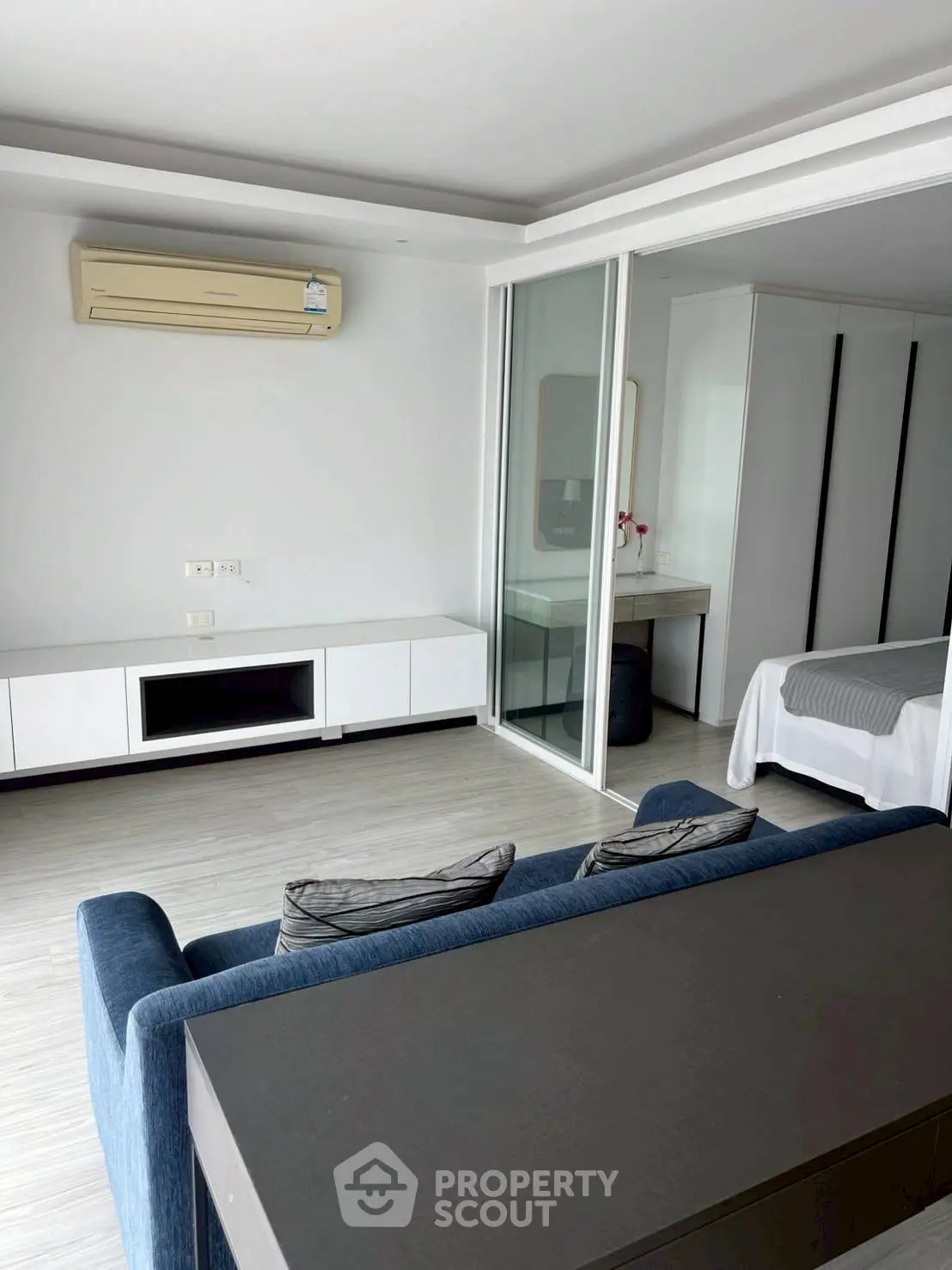 Modern living room with sleek design and sliding glass doors to bedroom