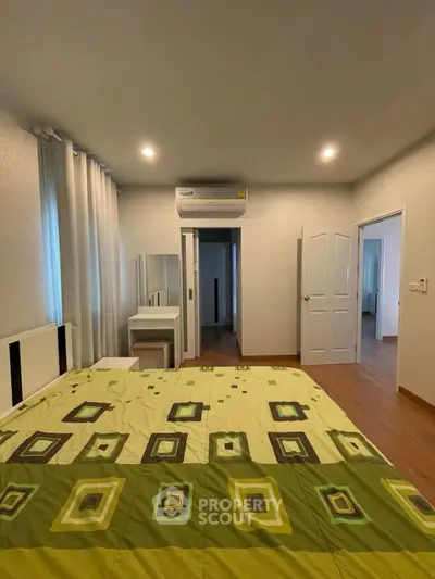 Spacious bedroom with modern decor and air conditioning unit