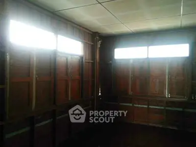 Rustic wooden interior with natural light filtering through windows, ideal for creative renovation.