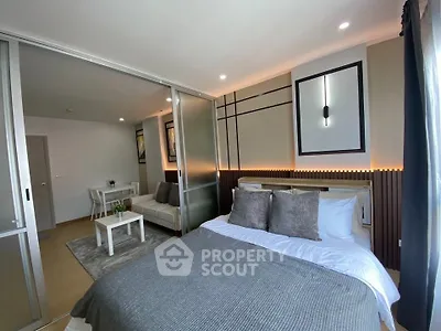 Modern bedroom with sliding glass doors and cozy living area