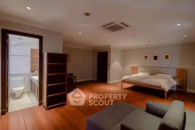Spacious bedroom with ensuite bathroom and modern furnishings in luxury apartment.