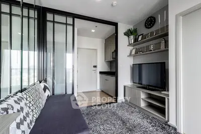 Modern living room with sleek decor and open layout, featuring a stylish sofa and wall-mounted TV.