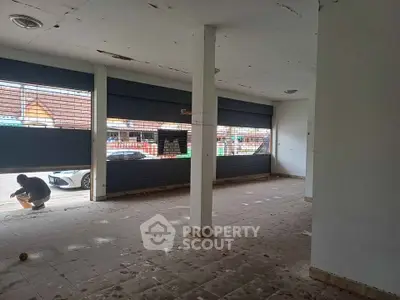 Spacious commercial property with large windows and tiled flooring, ideal for retail or office space.