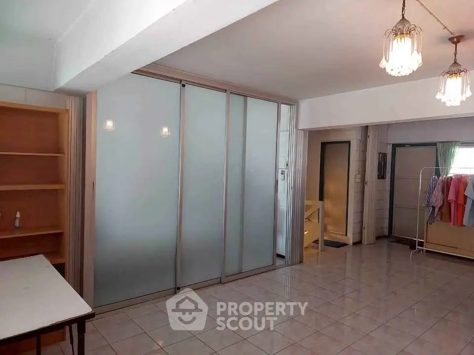 Spacious interior with sliding glass doors and elegant lighting, perfect for versatile living arrangements.