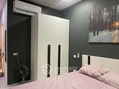 Modern bedroom with sleek wardrobe and air conditioning in stylish apartment.