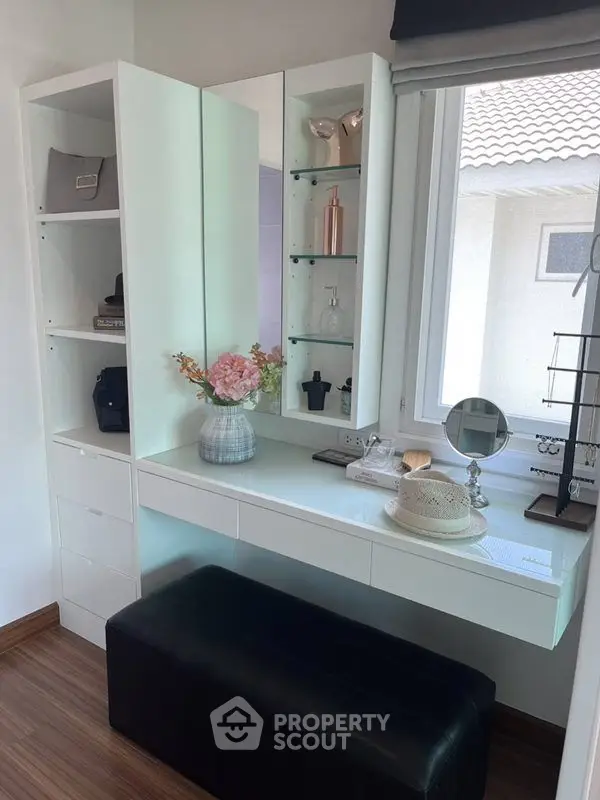 Chic vanity corner with ample storage and natural light, perfect for modern living spaces.