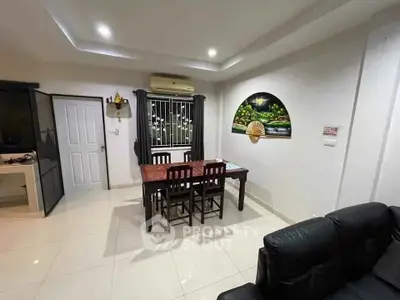 Modern dining area with sleek furniture and ambient lighting in a stylish apartment.
