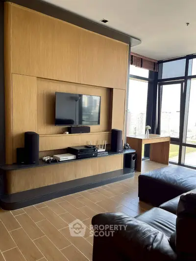 Modern living room with sleek entertainment center and city view