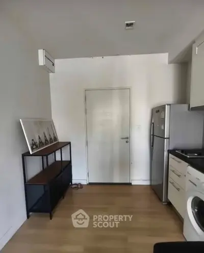 Compact kitchen with modern appliances and wooden flooring